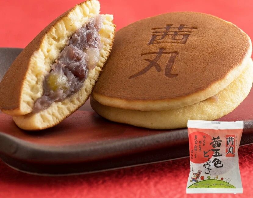 Akanemaru dorayaki, one cut open to show the red bean filling, with its individual wrapper (seller photo).