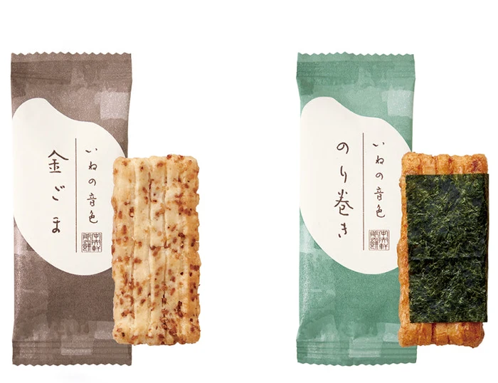 Two Ine no Neiro rice crackers beside their wrappers: golden sesame and nori-wrapped (maker photo).
